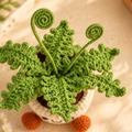 Collage showing a green crochet fern with curled stems in a smiling cream pot with orange feet