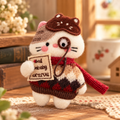 Handcrafted bookish cat plush brooch with embroidered whiskers, red scarf, patterned outfit, and decorative monocle