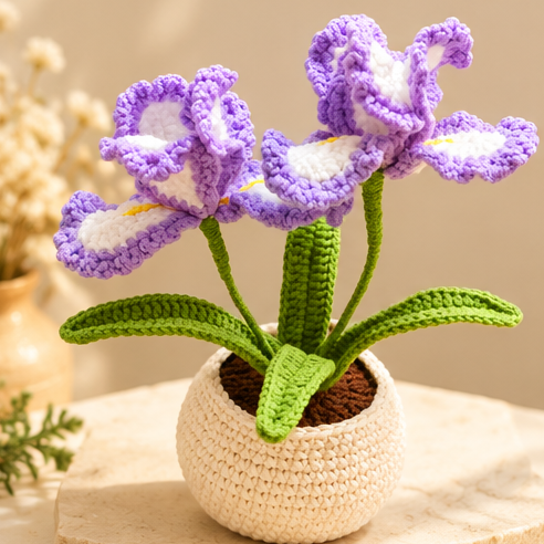 Purple and white crochet iris flowers with green leaves in a cream crochet pot, shown from multiple angles.