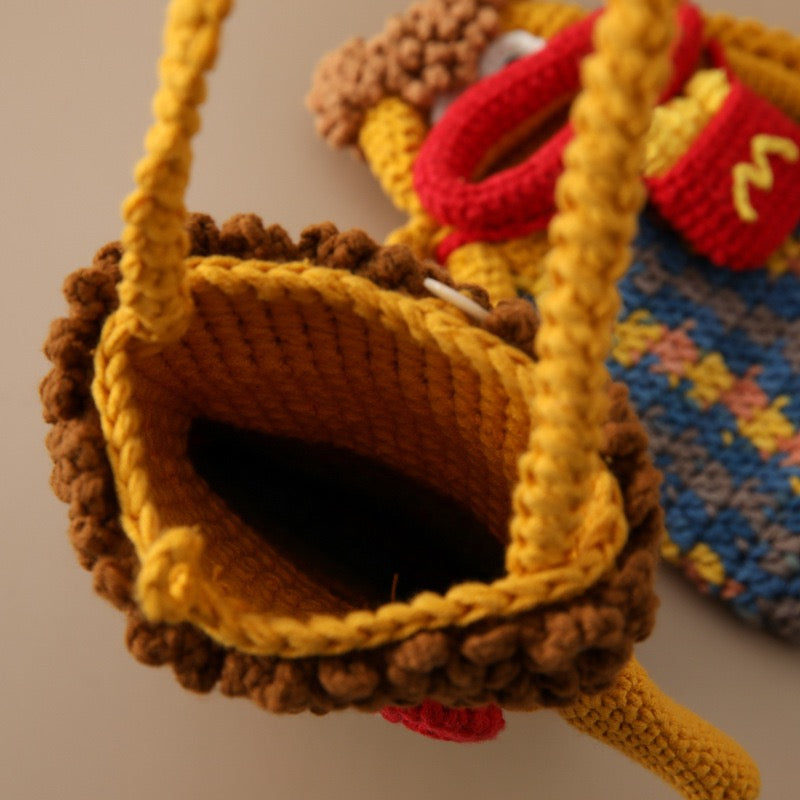Close-up of the open top and crocheted shoulder straps of a character bag