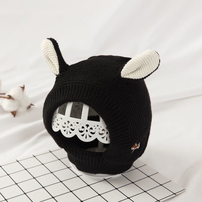 Red knitted animal ear dog hood with cream inner ears.