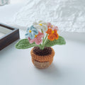 Yellow crochet flower cluster in a miniature cream pot.