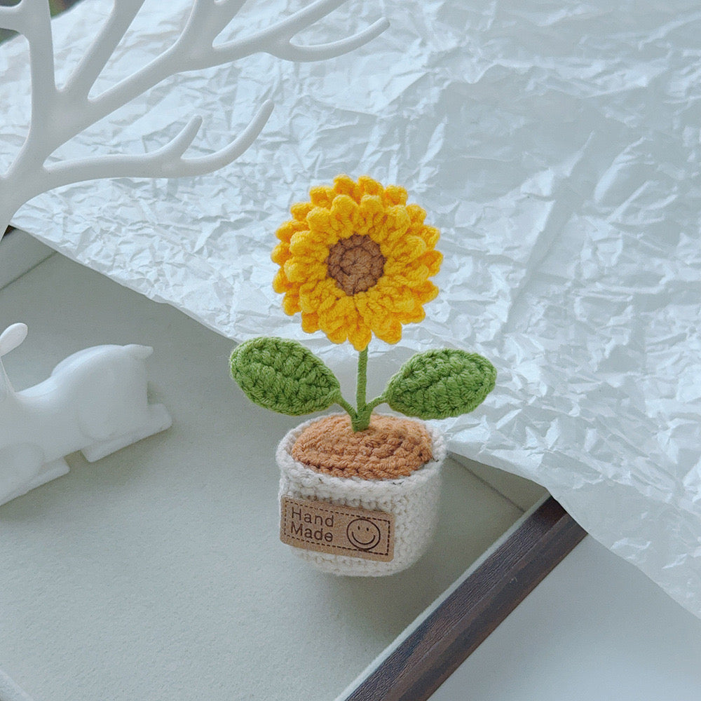 Multicolor crochet flower bouquet in a tan pot.