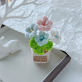 Two-tone blue crochet bouquet in a tan pot.