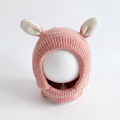 Pink knitted animal ear dog hood on a clean white background.