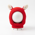 Red knitted animal ear dog hood on a clean white background.